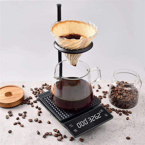 Coffee scale with timer weighing a pour-over brew in progress with glass carafe
